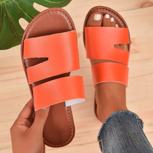Chic open toe flat sandals in orange red with double strap detail.