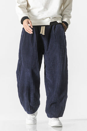 Navy corduroy wide-leg cargo pants with drawstring waist and vertical ribbing.
