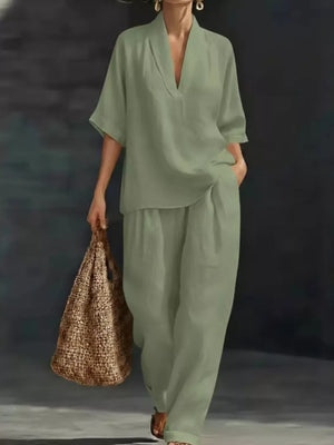 Light green half-sleeve top and wide-leg pants set with V-neck, worn by a woman carrying a straw bag.