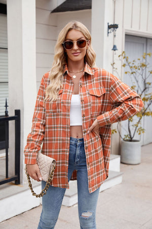Orange plaid overshirt with patch pockets and buttoned front, styled with jeans.