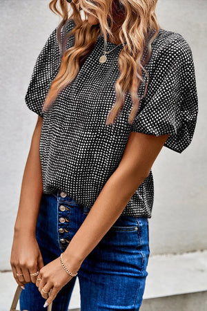 Black dotted puff sleeve blouse with round neckline.