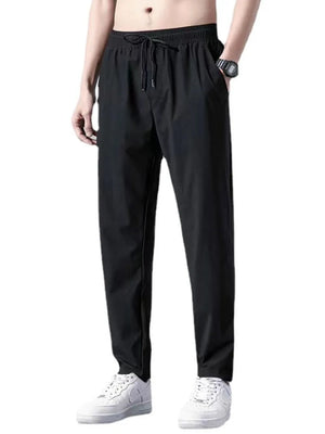Black relaxed-fit drawstring trousers with pockets and acetate fabric.
