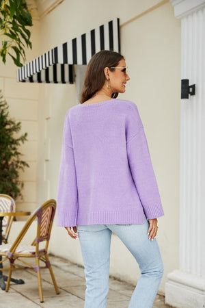 Relaxed fit lavender V-neck knit pullover sweater with ribbed cuffs and hem.