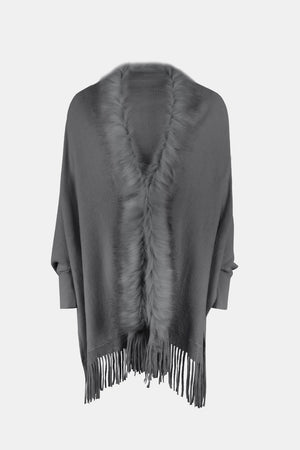 Charcoal faux fur trimmed fringe cape with a V-neck detail.