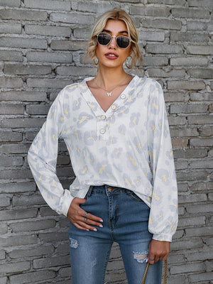 Light gray leopard print henley blouse with blouson sleeves and button detail.