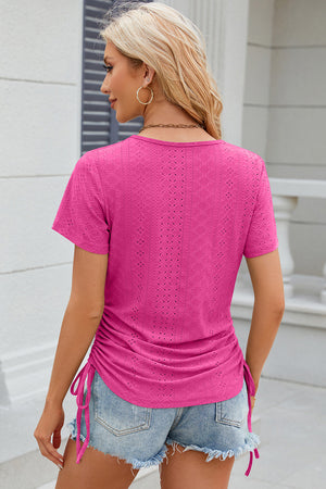 Hot pink tee with eyelet pattern and side ruching detail.