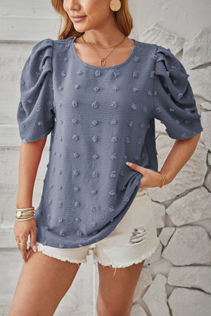 Textured puff-sleeve blouse in Dusty Pink with pom-poms.