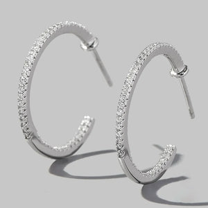 Silver pavé zirconia half-hoop earrings in 925 sterling silver.