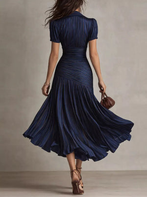 Navy ruched midi dress with pleated skirt and subtle pinstripes.
