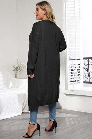 Black oversized knit maxi cardigan with long sleeves and a relaxed fit.