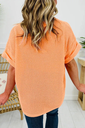 Waffle knit t-shirt in sherbet orange with cuffed short sleeves.