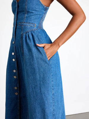 Denim midi dress with button front, smocked sides, and pockets.