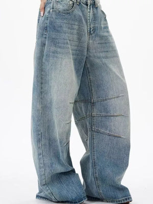 Men's light wash wide leg jeans with exaggerated fit and panel detailing.