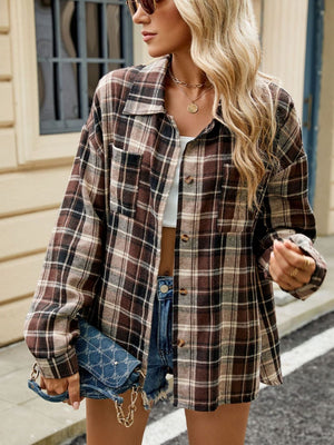 Brown plaid collared long sleeve shirt with button front and chest pockets.