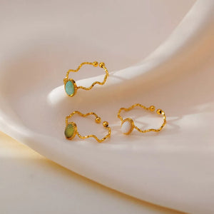 Wavy gold-plated ring with natural stone accents in cream, Style A, Style B, and Style C.