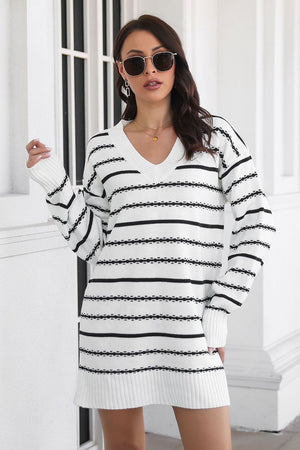 White and black striped knit mini dress with V-neck and long sleeves.