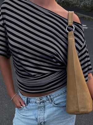 Cropped one-shoulder striped t-shirt in dark gray with a twisted hem detail.