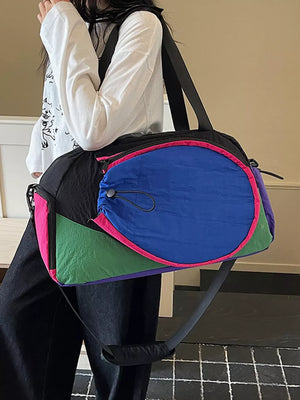 Vibrant nylon sport duffle bag with color block design and adjustable strap.