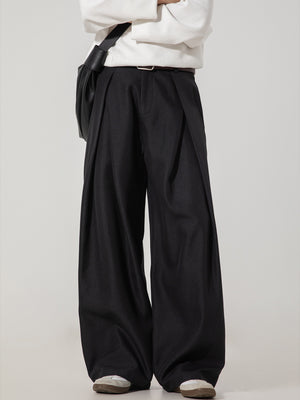 Men's black wide-leg trousers with pleats and a belted waist.