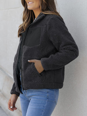 Sherpa zip-up jacket in dark gray with black patch pocket and side pockets.