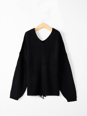 Black knit sweater with V-neck and lace-up detail at hem