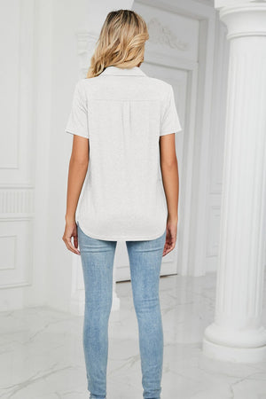 Light gray short sleeve V-neck polo with pocket detail and a curved hem.
