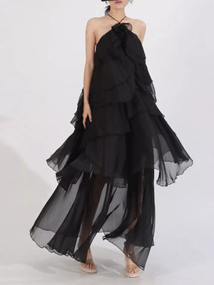Black ruffle halter maxi dress with cascading tiers and sheer skirt.