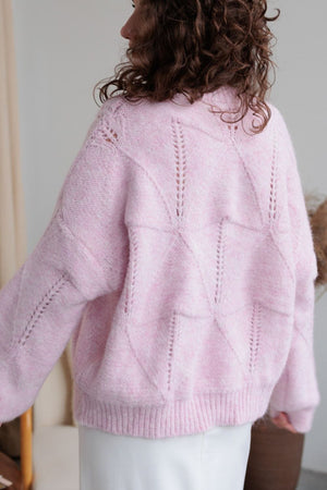 Blush pink diamond knit sweater with open stitch details and ribbed cuffs and hem.