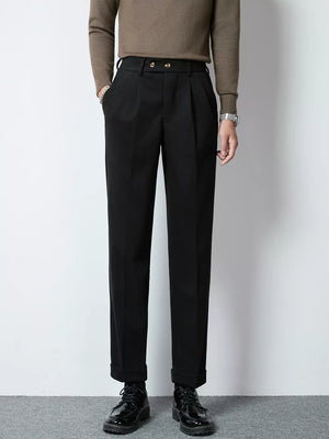 Men's black tailored pleated trousers with cuffed hems and double button closure.