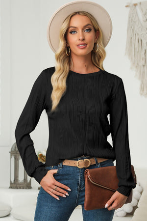 Black crewneck pullover with textured wave pattern and long sleeves.