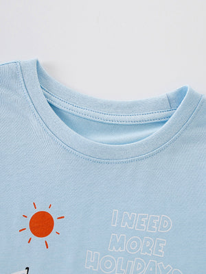 Light blue cotton baby t-shirt with sun graphic and text I NEED MORE HOLIDAYS
