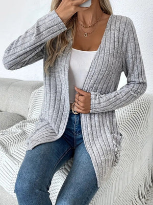 Light gray ribbed knit cardigan with a drape front and pockets, worn open over a white tank top.