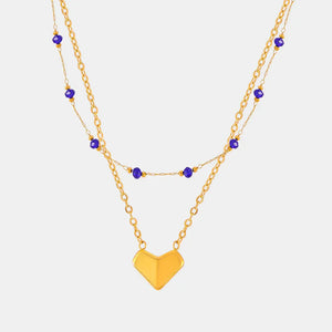 Gold layered necklace with blue beads and a heart pendant