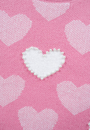 Pink knit sweater with white intarsia hearts and pearl-embellished heart detail.