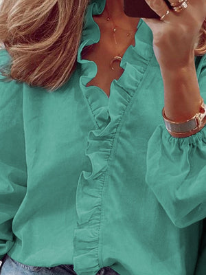 Teal blouse with cascading ruffle front and balloon sleeves.