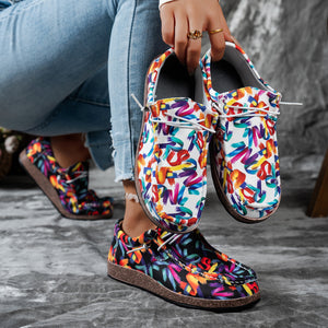 Printed casual slip-on loafers with abstract brushstroke pattern in white and black.