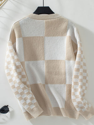 Checkerboard knit sweater in tan and white with crew neck and long sleeves.