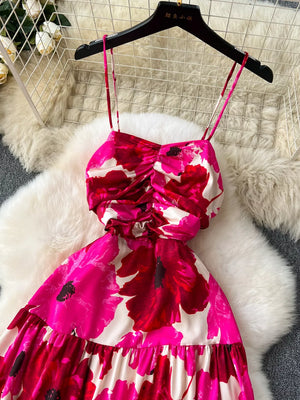Vibrant floral tiered cami dress with ruched bodice and spaghetti straps.