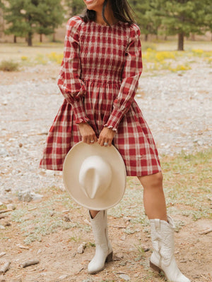 Red plaid cotton mini dress with smocked bodice, puff sleeves, and ruffled cuffs.