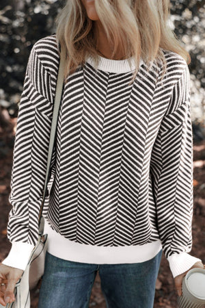 Chevron knit crewneck sweater in black and white with white cuffs and hem.