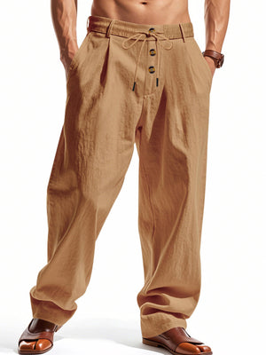 Men's light khaki drawstring loose fit pants with button fly and pleats.