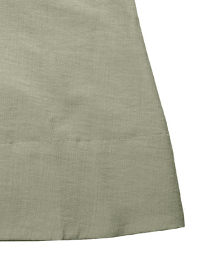 Elegant smocked waist maxi dress in sage green linen blend fabric, showing textured detail.
