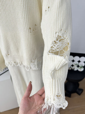 Off white distressed cotton sweater set with deconstructed details and frayed hem.