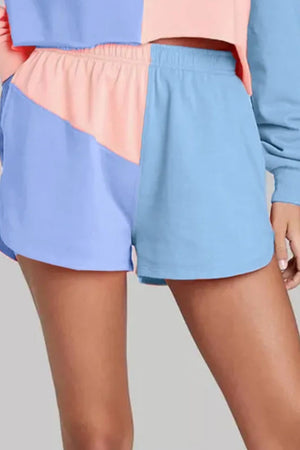 Colorblock lounge shorts in light blue and dusty pink with an elastic waistband.