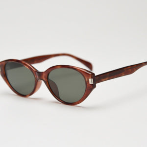 Elegant cat-eye sunglasses in tortoiseshell acetate with dark lenses and UV protection.