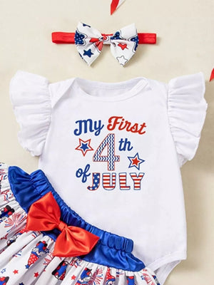 White baby outfit with "My First 4th of July" print, ruffled sleeves, and patriotic skirt.