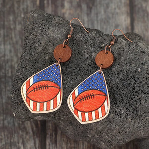 Patriotic football woodcut dangle earrings with American flag design.