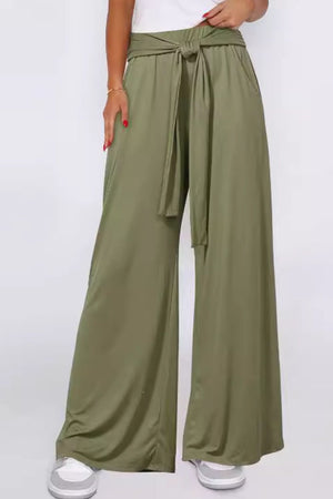 Moss wide-leg flow pants with self-tie waist, styled casually.