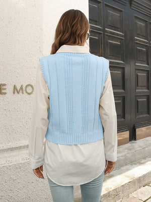 Pastel blue acrylic cable knit crop vest sweater with ribbed trim and vertical stitch detail.