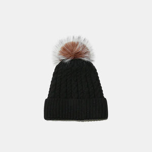 Black acrylic cable knit beanie with a fluffy pom pom